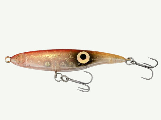 A side view of a silver-colored fishing lure with a minimalistic design, featuring two hooks and a small yellow detail on the head.